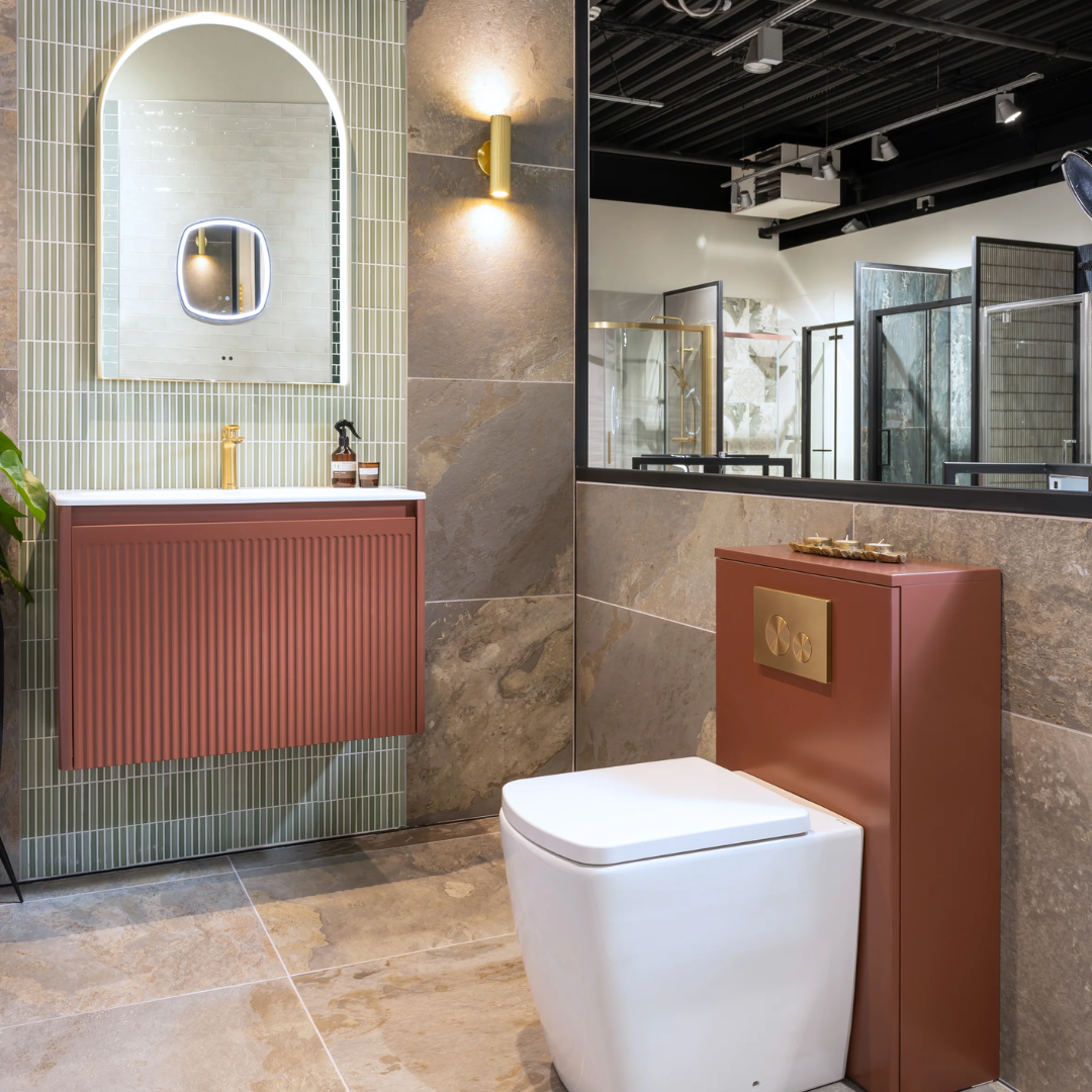 Elegant bathroom suite with traditional vanity, high-level toilet, and patterned floor tiles on display in Wolverhampton - Local Bathroom Showroom - Wolverhampton